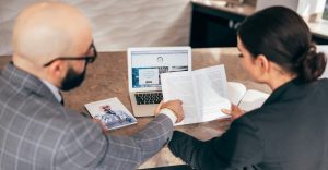 Bookkeeper and sole trader client reviewing financial documents together