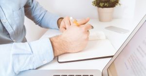 Business owner reviewing VAT figures on a laptop, considering the VAT Flat Rate Scheme