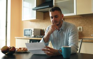 Business owner carefully reading a formal letter from HMRC regarding a tax compliance check